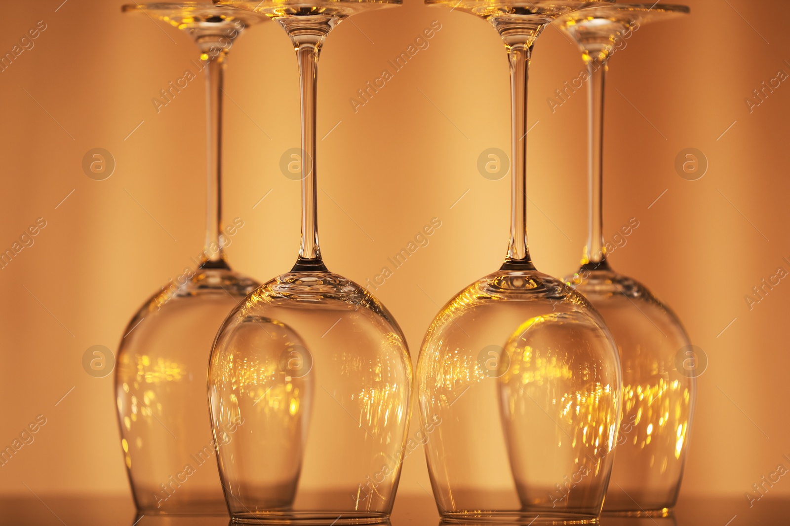 Clean upturned glasses on beige background, closeup Photo of Clean upturned glasses on beige background, closeup