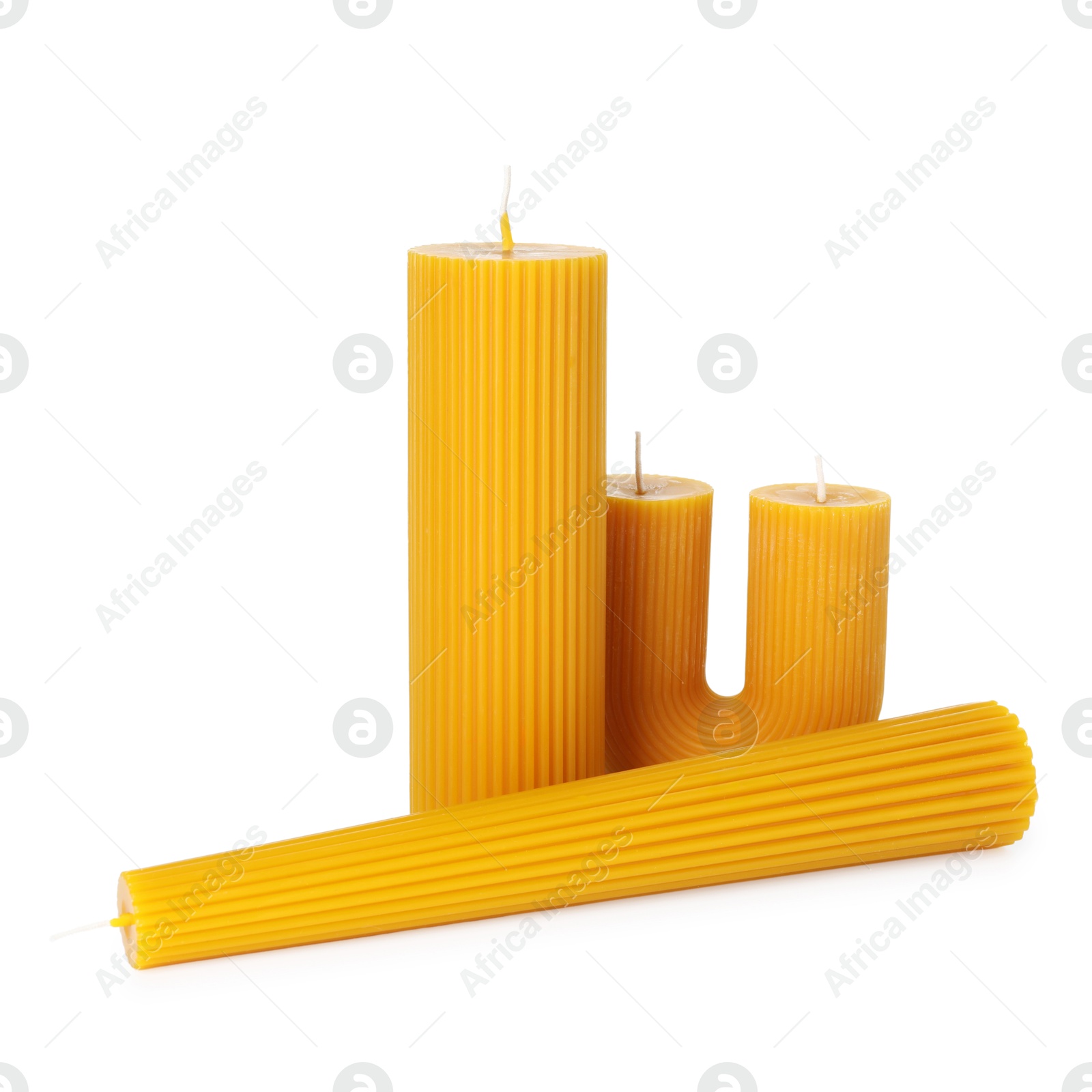 Three beautiful beeswax candles isolated on white Photo of Three beautiful beeswax candles isolated on white