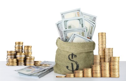Image of Wealth. Stacked coins and burlap bag full of dollar bills isolated on white