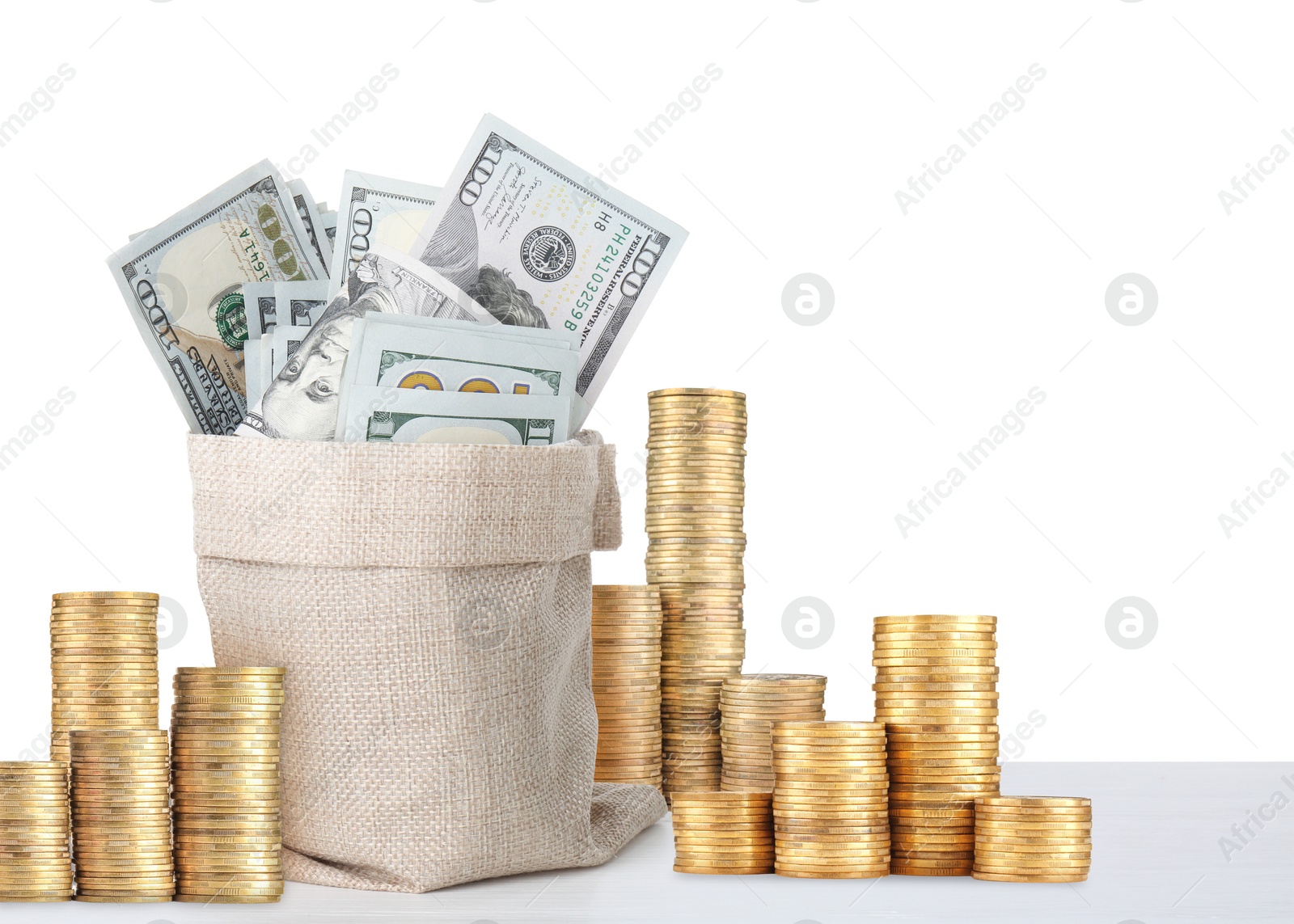 Wealth. Stacked coins and burlap bag full of dollar bills isolated on white Image of Wealth. Stacked coins and burlap bag full of dollar bills isolated on white