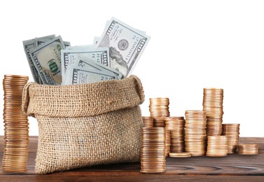 Image of Wealth. Stacked coins and burlap bag full of dollar bills isolated on white