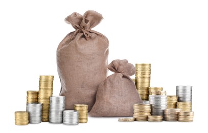 Image of Wealth. Stacked coins and burlap bags isolated on white