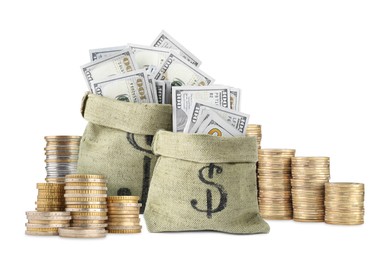 Image of Wealth. Stacked coins and burlap bags full of dollar bills isolated on white