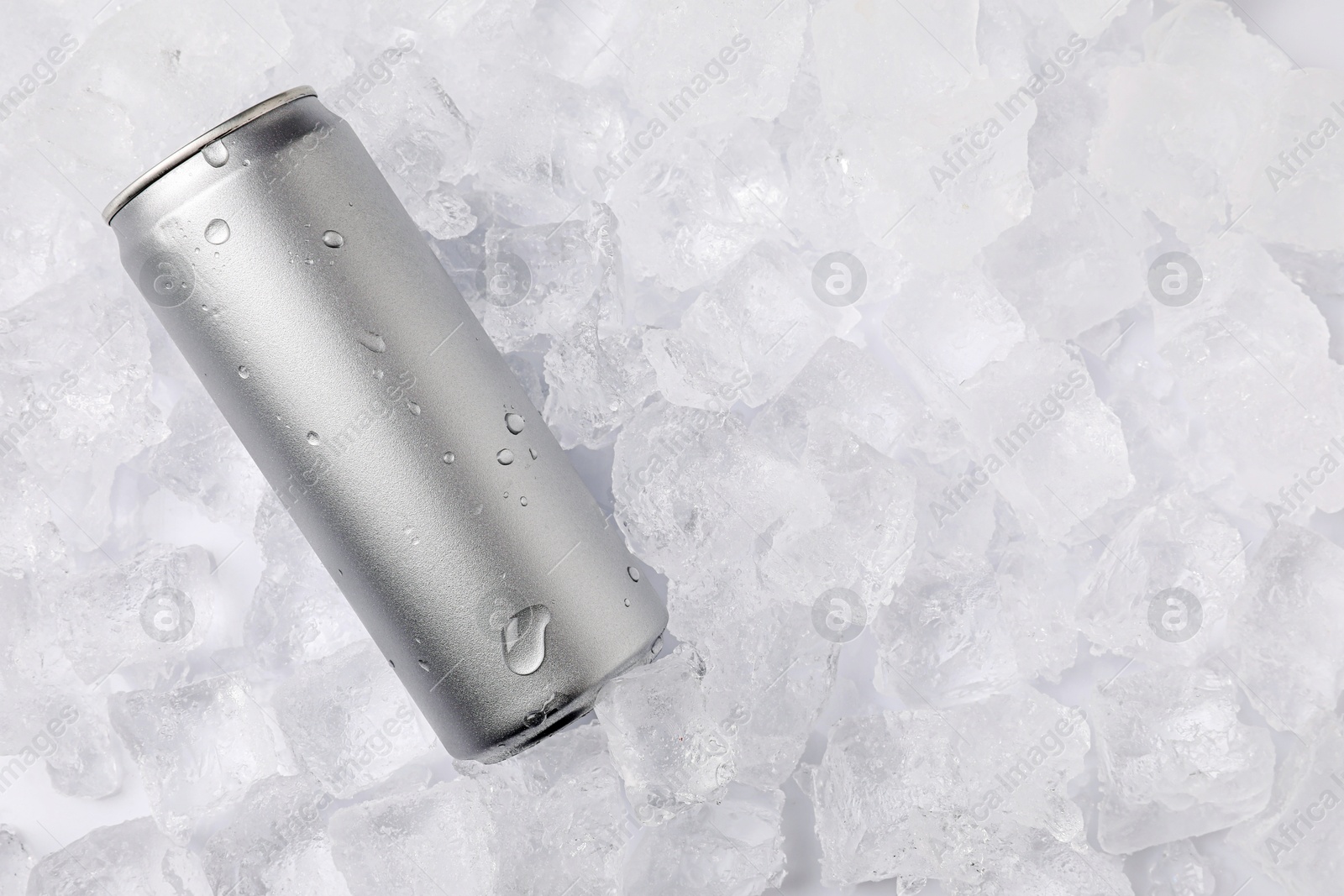 Refreshing drink in can on ice cubes, top view. Space for text Photo of Refreshing drink in can on ice cubes, top view. Space for text