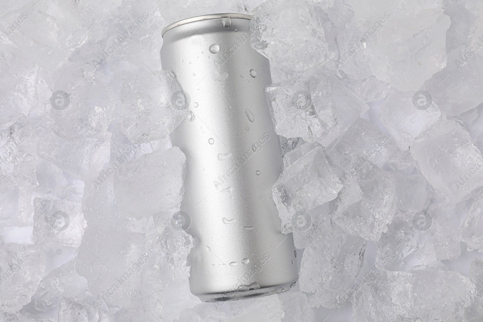 Refreshing drink in can on ice cubes, top view. Space for text Photo of Refreshing drink in can on ice cubes, top view. Space for text