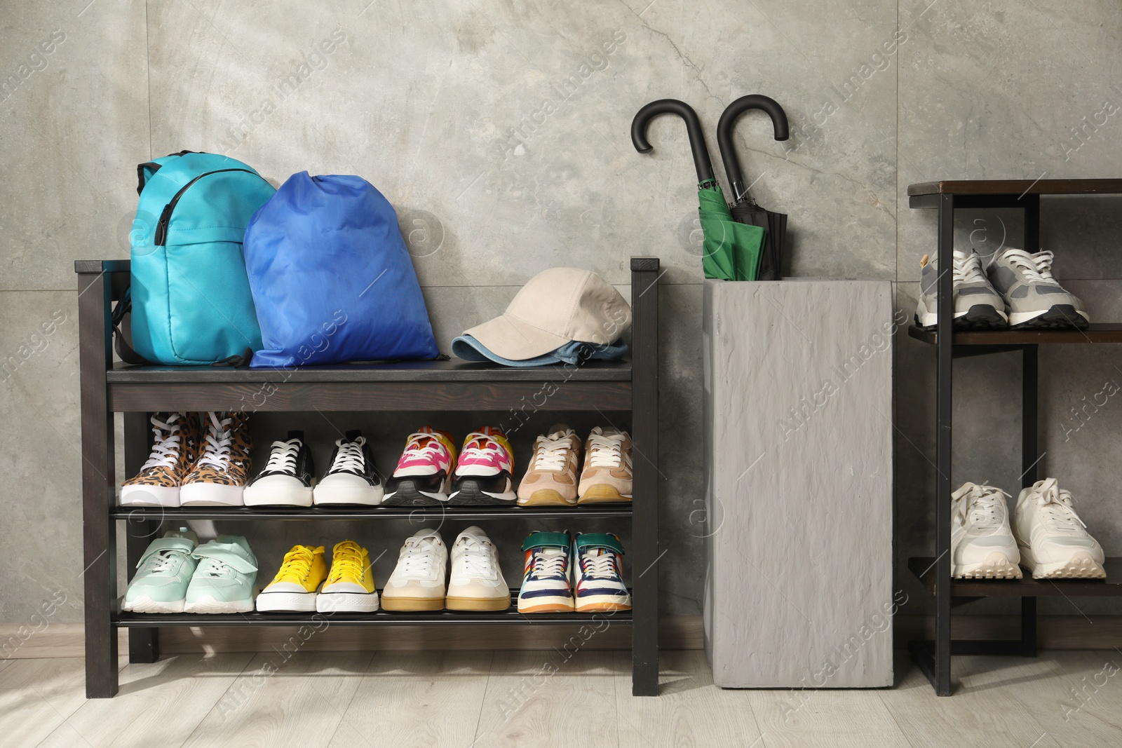 Shoe storage bench with different footwear and other accessories indoors Photo of Shoe storage bench with different footwear and other accessories indoors