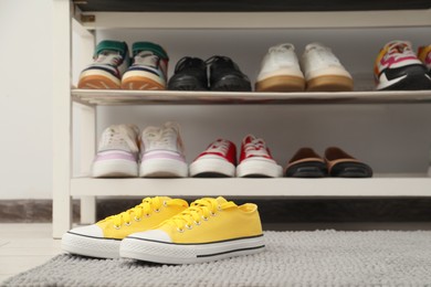 Photo of Shoe storage bench with different footwear indoors