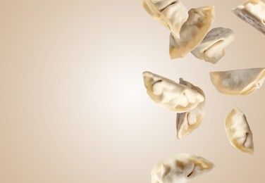 Image of Uncooked gyoza in air on dark beige background, space for text