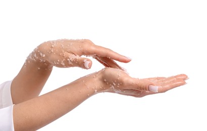 Photo of Woman applying body scrub onto her hands on white background, closeup