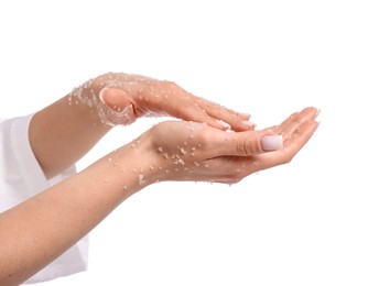 Photo of Woman applying body scrub onto her hands on white background, closeup