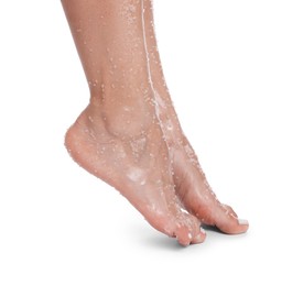 Photo of Woman with body scrub on her feet against white background, closeup