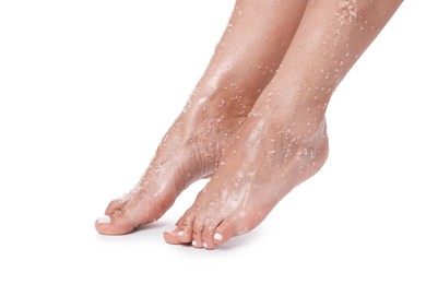 Photo of Woman with body scrub on her feet against white background, closeup