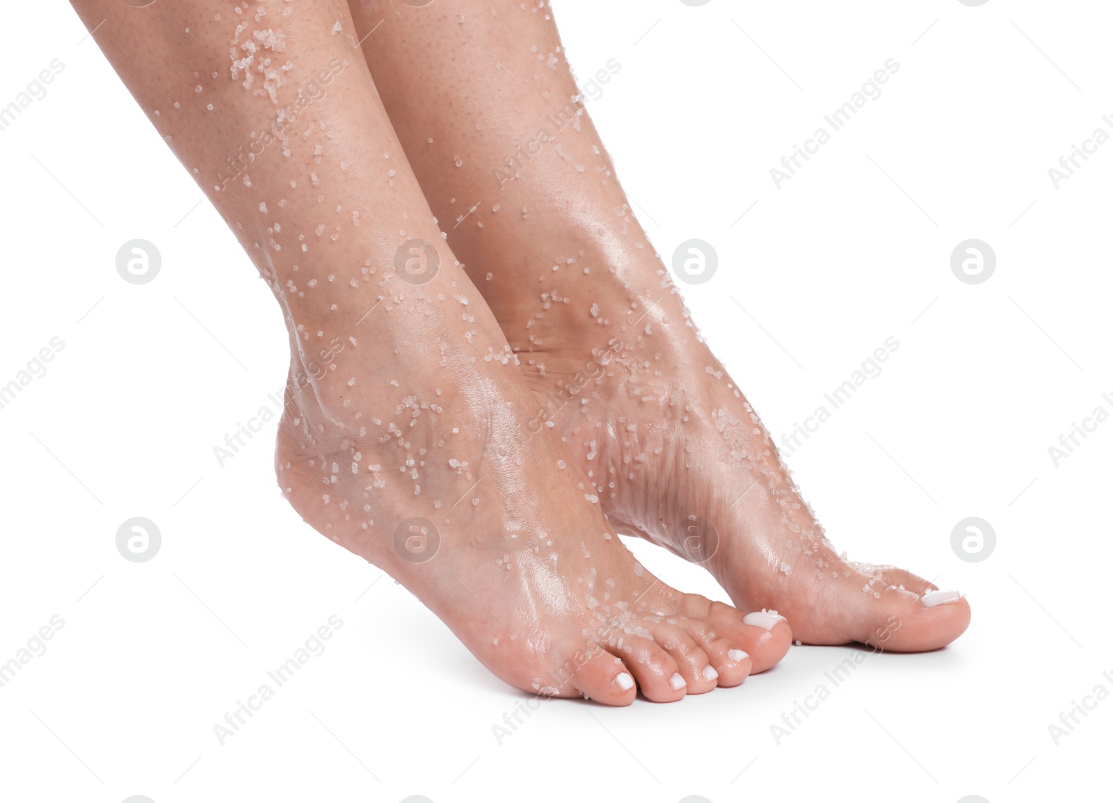 Woman with body scrub on her feet against white background, closeup Photo of Woman with body scrub on her feet against white background, closeup