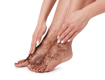 Photo of Woman applying body scrub onto her feet on white background, closeup