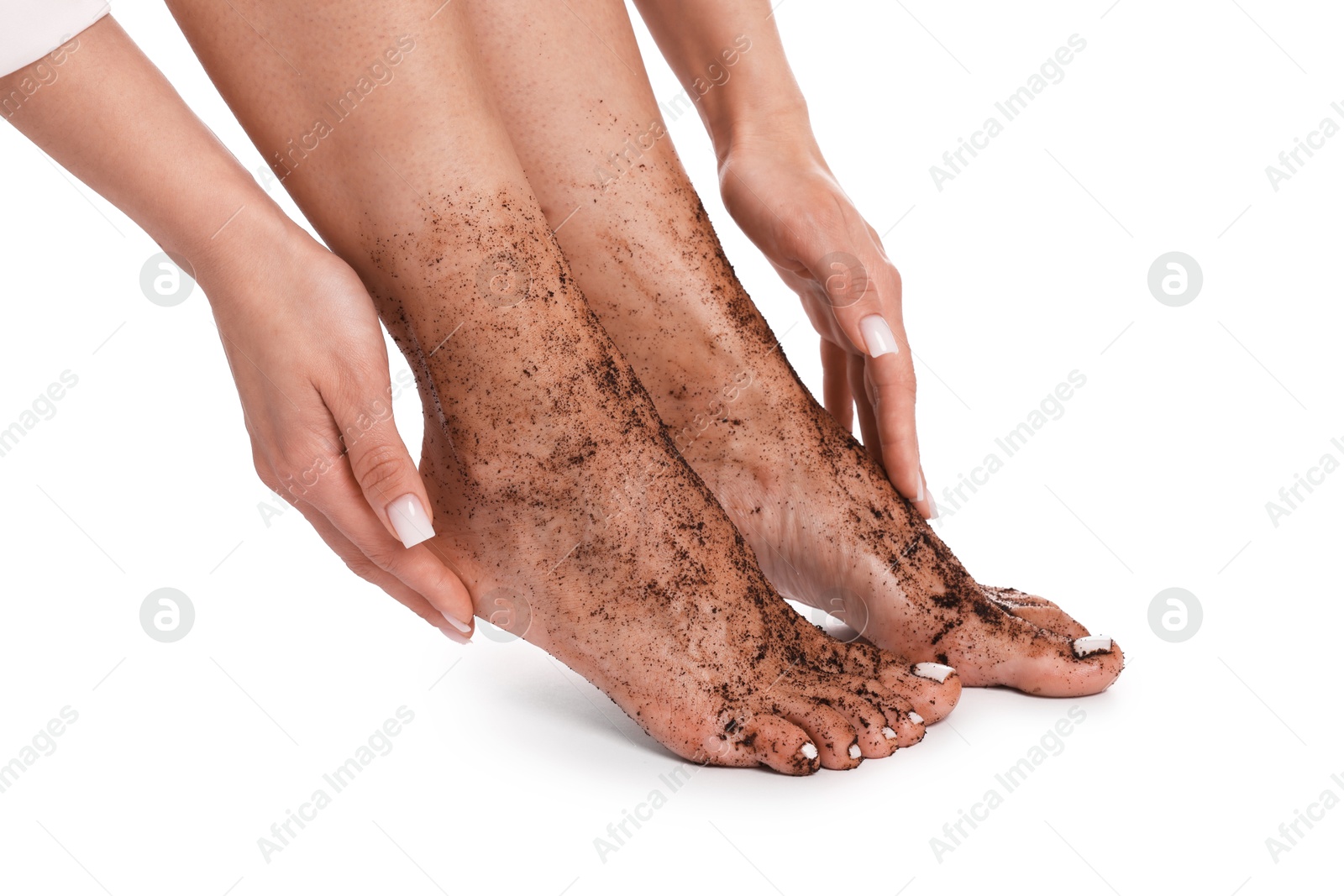 Woman applying body scrub onto her feet on white background, closeup Photo of Woman applying body scrub onto her feet on white background, closeup