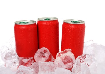 Photo of Refreshing drinks in cans on ice cubes against white background