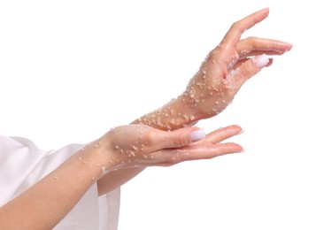 Photo of Woman applying body scrub onto her hands on white background, closeup