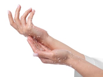 Photo of Woman applying body scrub onto her hands on white background, closeup