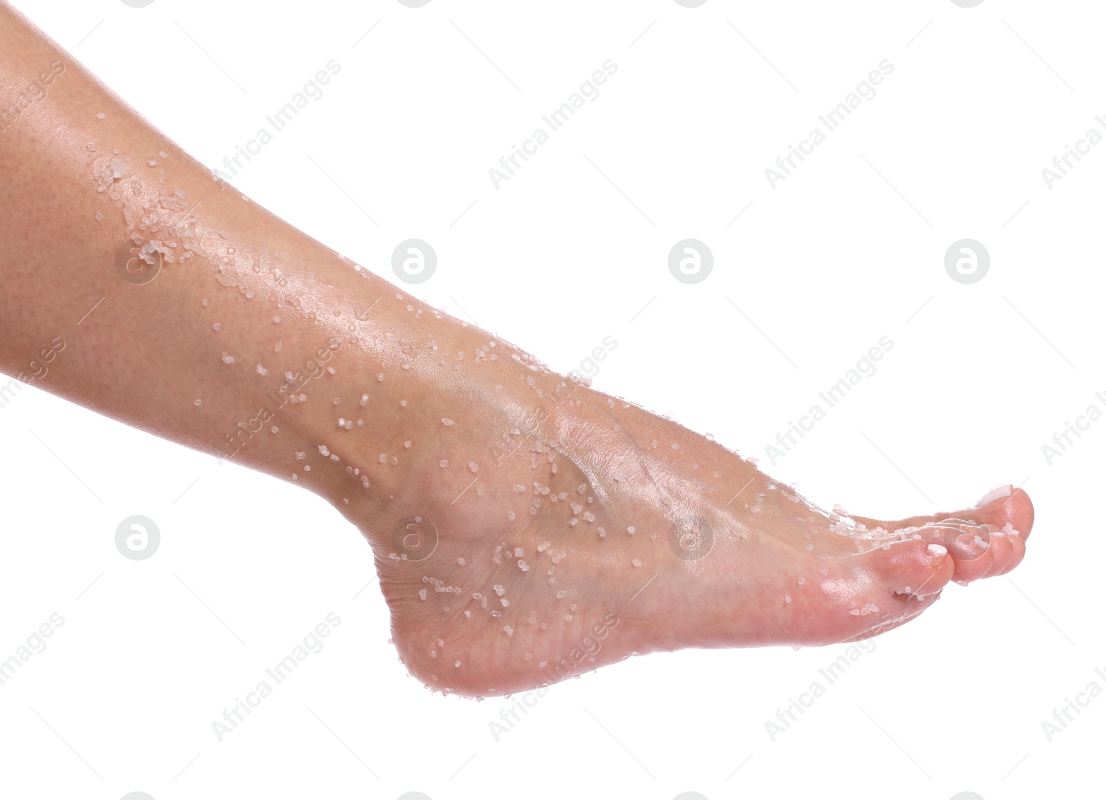 Woman with body scrub on her foot against white background, closeup Photo of Woman with body scrub on her foot against white background, closeup