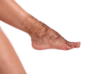 Photo of Woman with body scrub on her foot against white background, closeup