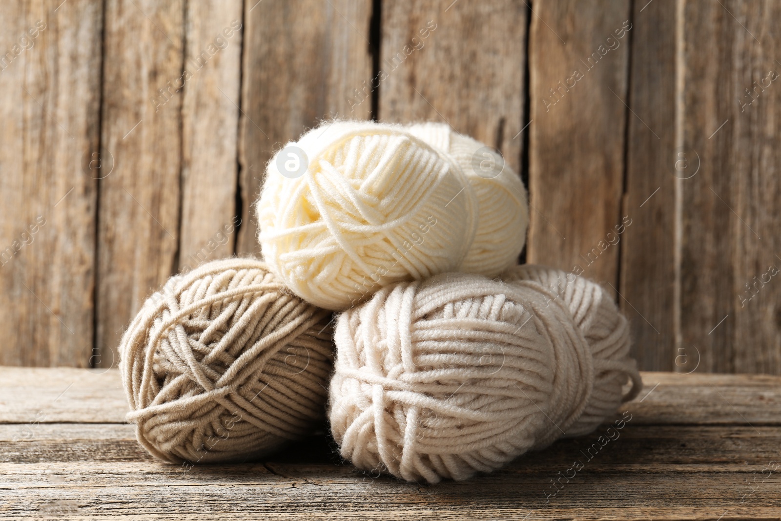 Skeins of yarn on wooden table, closeup Photo of Skeins of yarn on wooden table, closeup