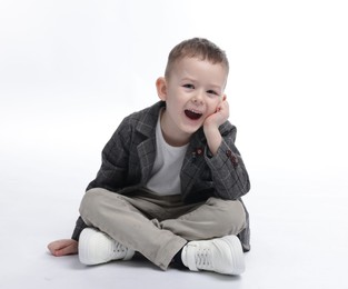 Photo of Portrait of cute little boy on white background