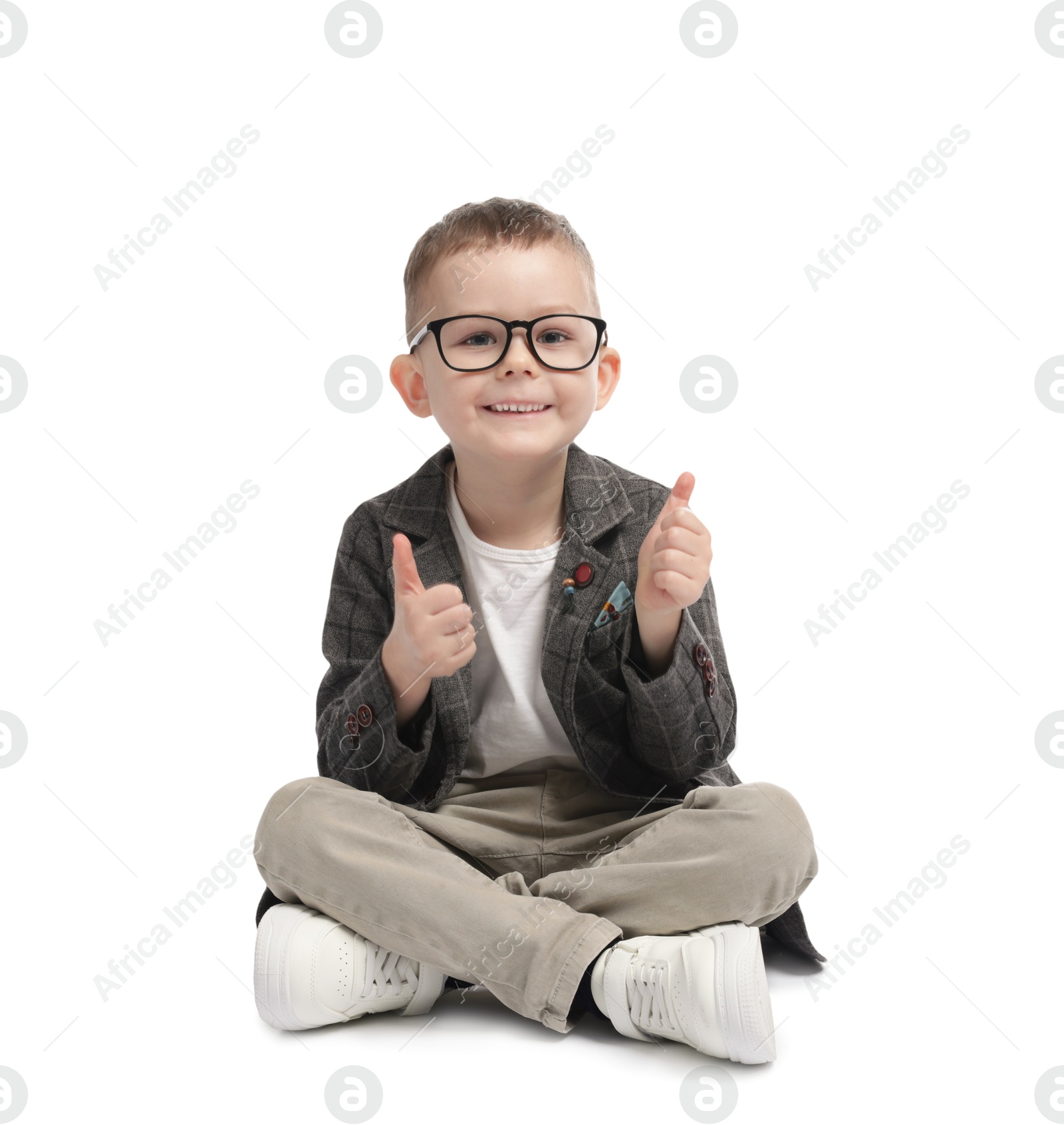 Cute little boy in glasses showing thumbs up on white background Photo of Cute little boy in glasses showing thumbs up on white background