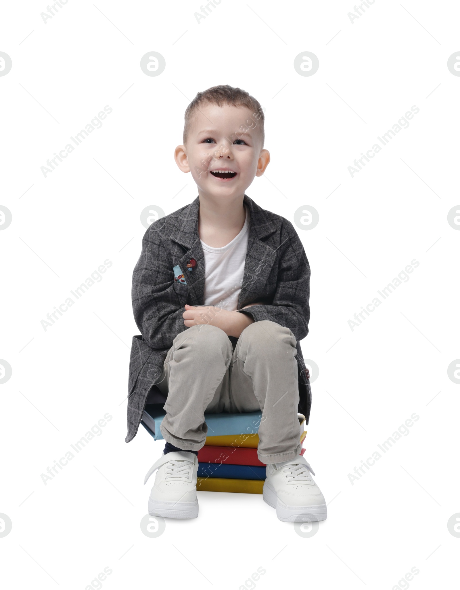 Cute little boy on books against white background Photo of Cute little boy on books against white background
