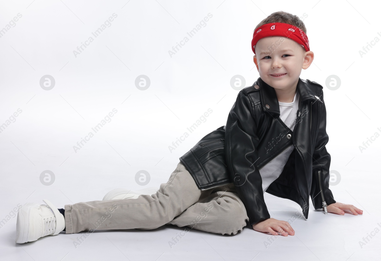 Cute little boy in black leather jacket on white background Photo of Cute little boy in black leather jacket on white background