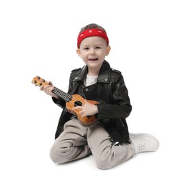 Photo of Cute little boy playing toy guitar on white background