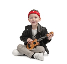 Photo of Cute little boy playing toy guitar on white background