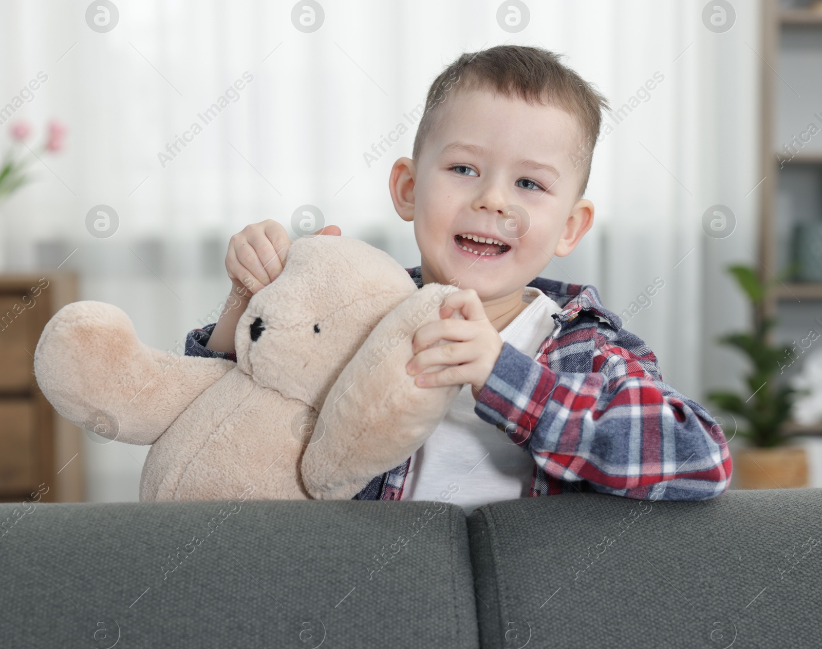 Cute little boy with toy bear at home Photo of Cute little boy with toy bear at home