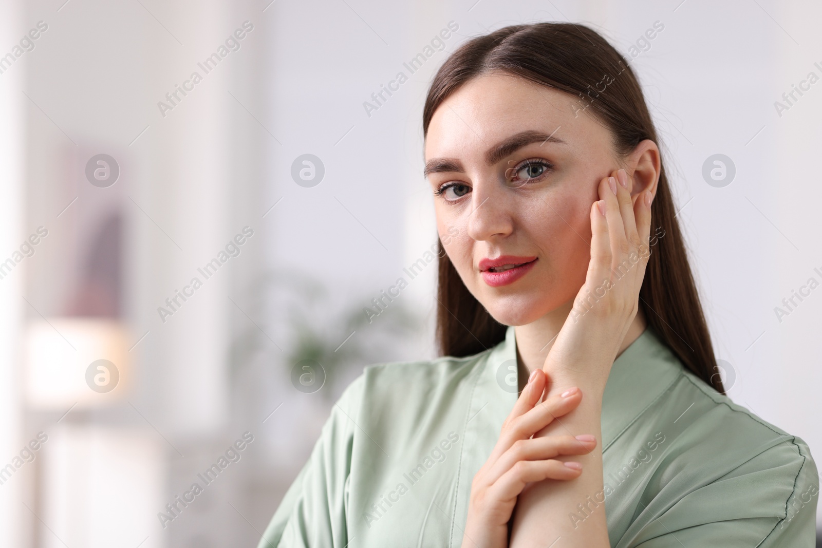 Woman with healthy skin on blurred background. Space for text Photo of Woman with healthy skin on blurred background. Space for text
