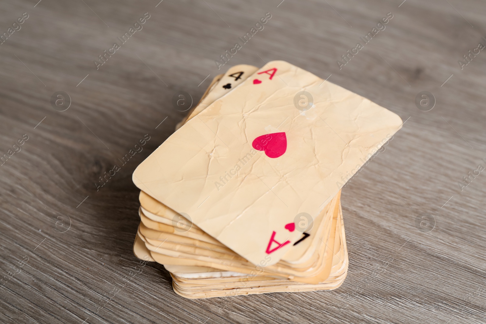 Many old vintage playing cards on wooden table, closeup Photo of Many old vintage playing cards on wooden table, closeup