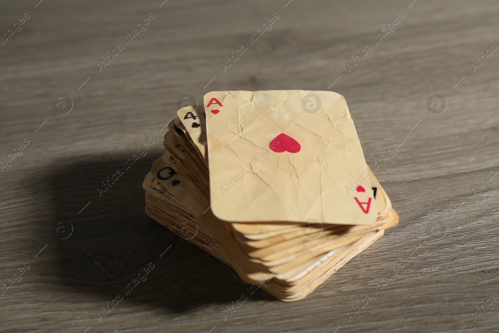 Many old vintage playing cards on wooden table, closeup Photo of Many old vintage playing cards on wooden table, closeup