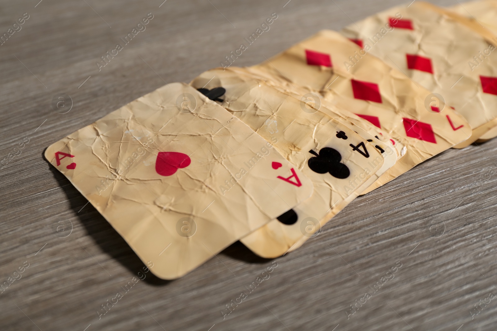 Many old vintage playing cards on wooden table, closeup Photo of Many old vintage playing cards on wooden table, closeup