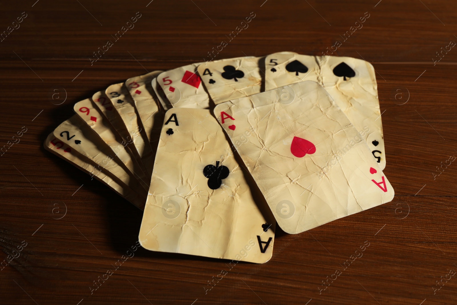 Old vintage playing cards on wooden table, closeup Photo of Old vintage playing cards on wooden table, closeup