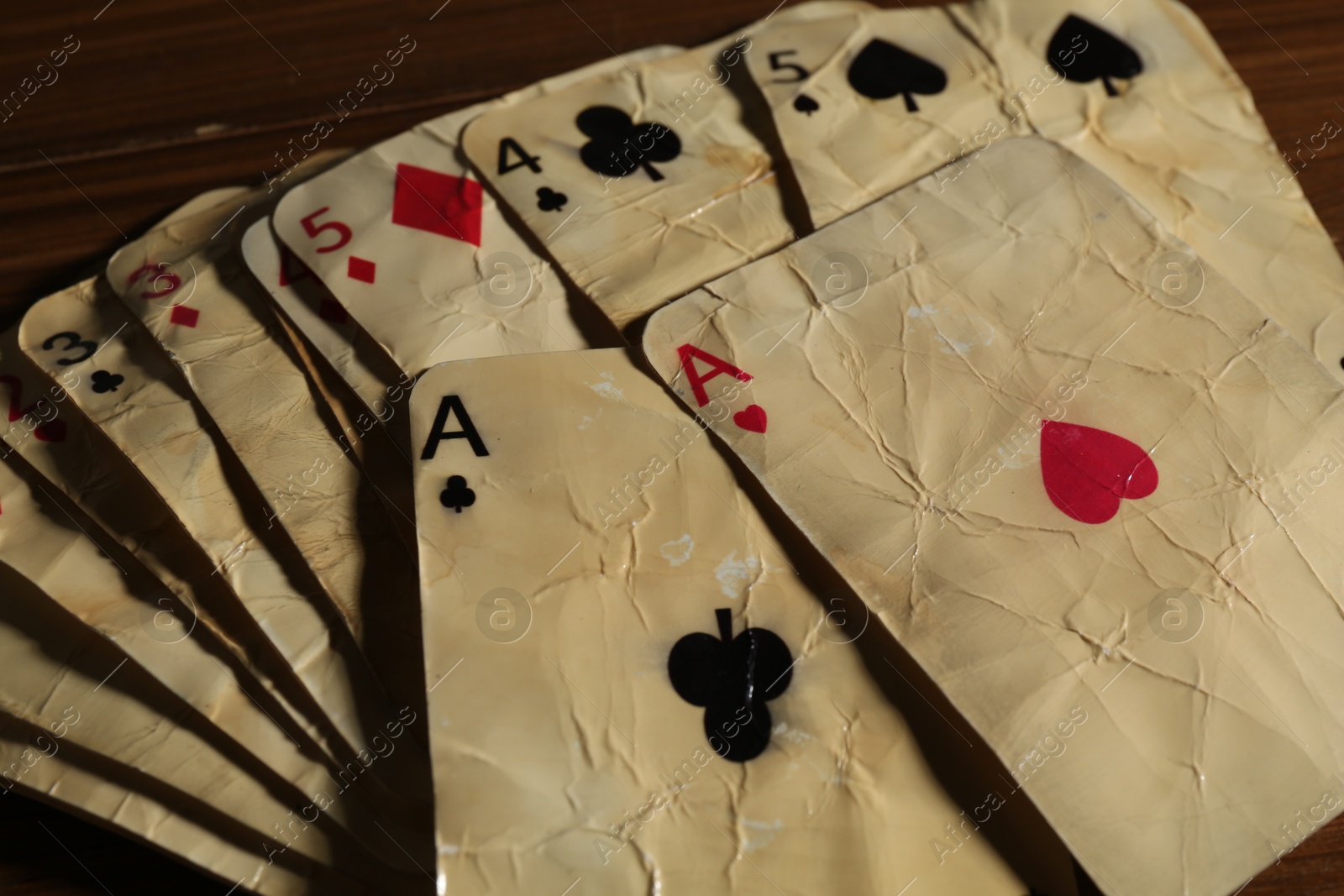 Old vintage playing cards on wooden table, closeup Photo of Old vintage playing cards on wooden table, closeup