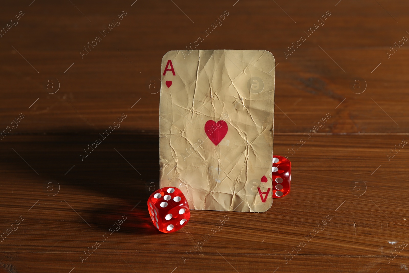 Old vintage playing card and dices on wooden table Photo of Old vintage playing card and dices on wooden table