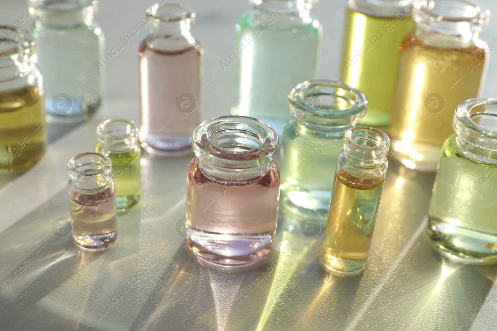 Perfume bottles with aromatic oils on light background, closeup Photo of Perfume bottles with aromatic oils on light background, closeup