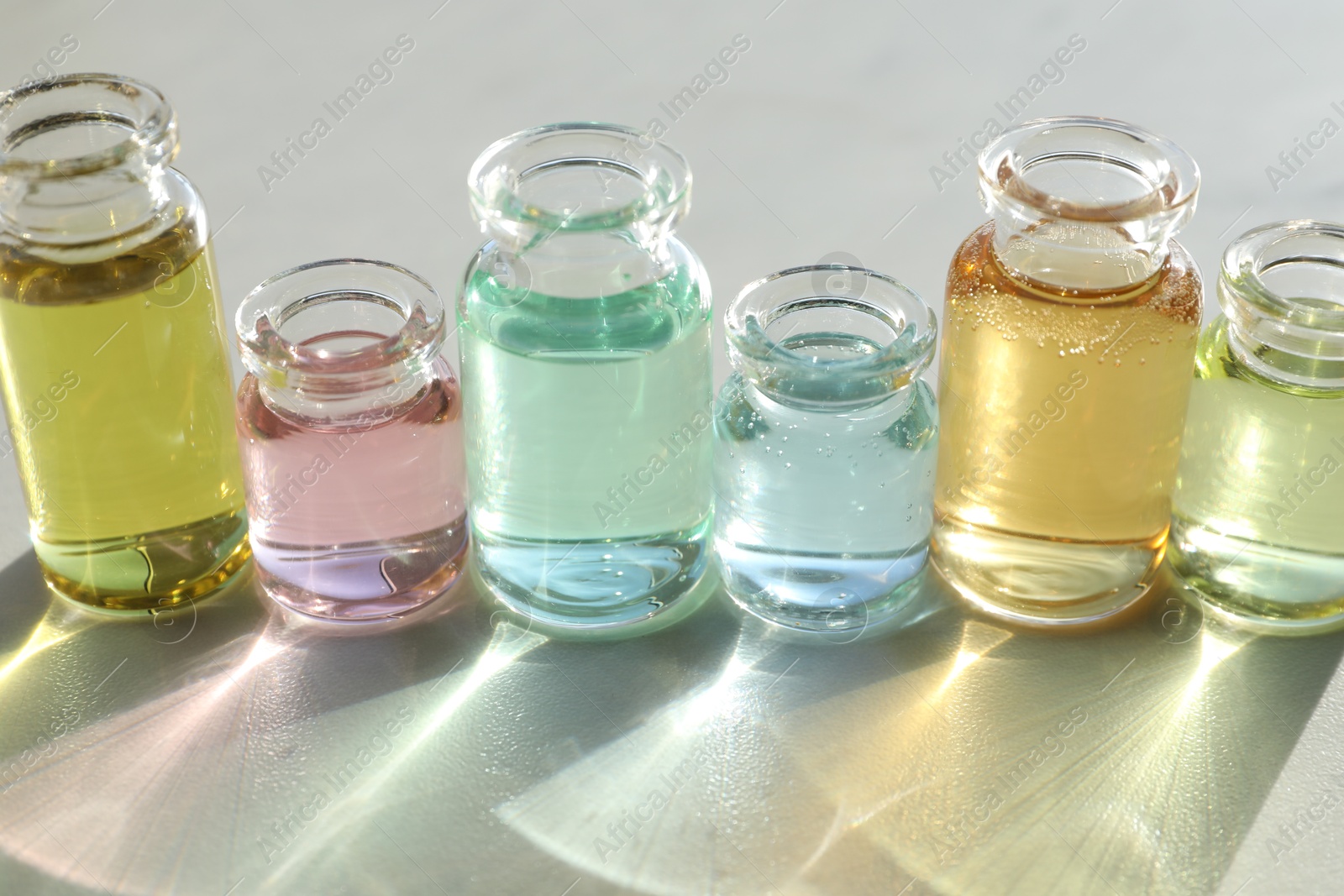 Perfume bottles with aromatic oils on light background, closeup Photo of Perfume bottles with aromatic oils on light background, closeup