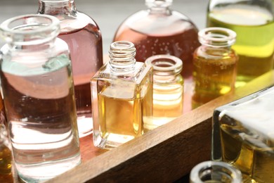 Photo of Perfume bottles with aromatic oils on background, closeup