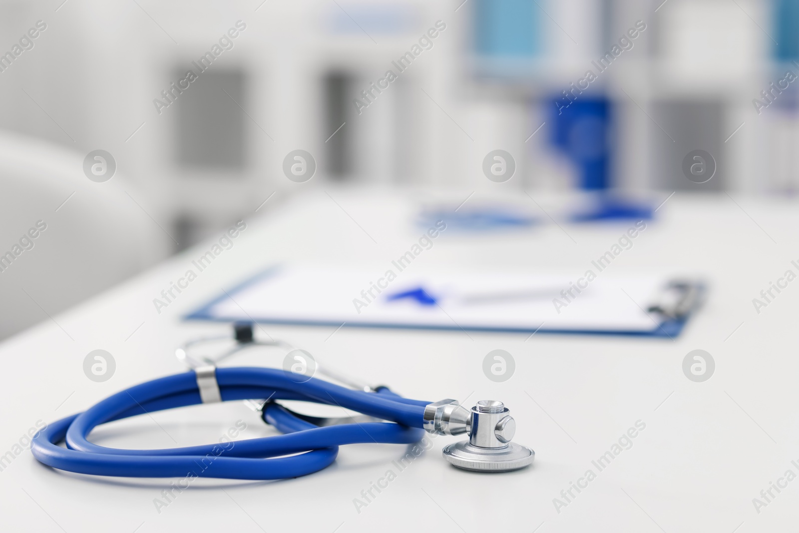 Stethoscope and paperwork on desk in doctor's office. Space for text Photo of Stethoscope and paperwork on desk in doctor's office. Space for text