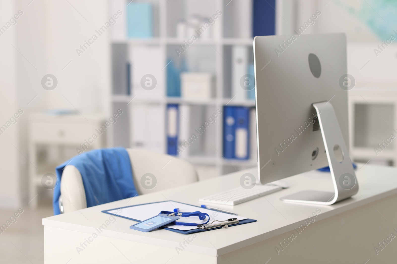 Doctor's workplace with stethoscope, paperwork and computer on desk. Space for text Photo of Doctor's workplace with stethoscope, paperwork and computer on desk. Space for text