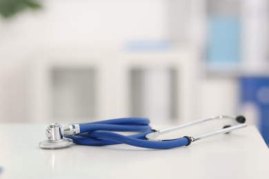 Photo of Stethoscope on desk in doctor's office, closeup. Space for text