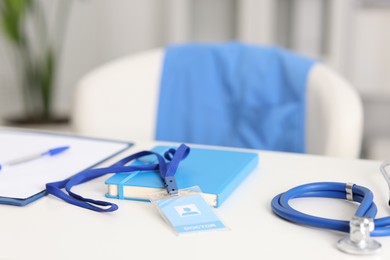 Photo of Doctor's workplace with stethoscope and paperwork on desk, closeup. Space for text