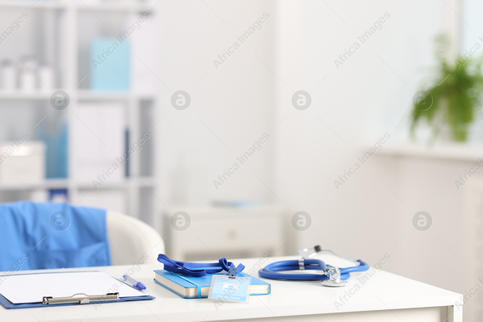 Doctor's workplace with stethoscope and paperwork on desk. Space for text Photo of Doctor's workplace with stethoscope and paperwork on desk. Space for text