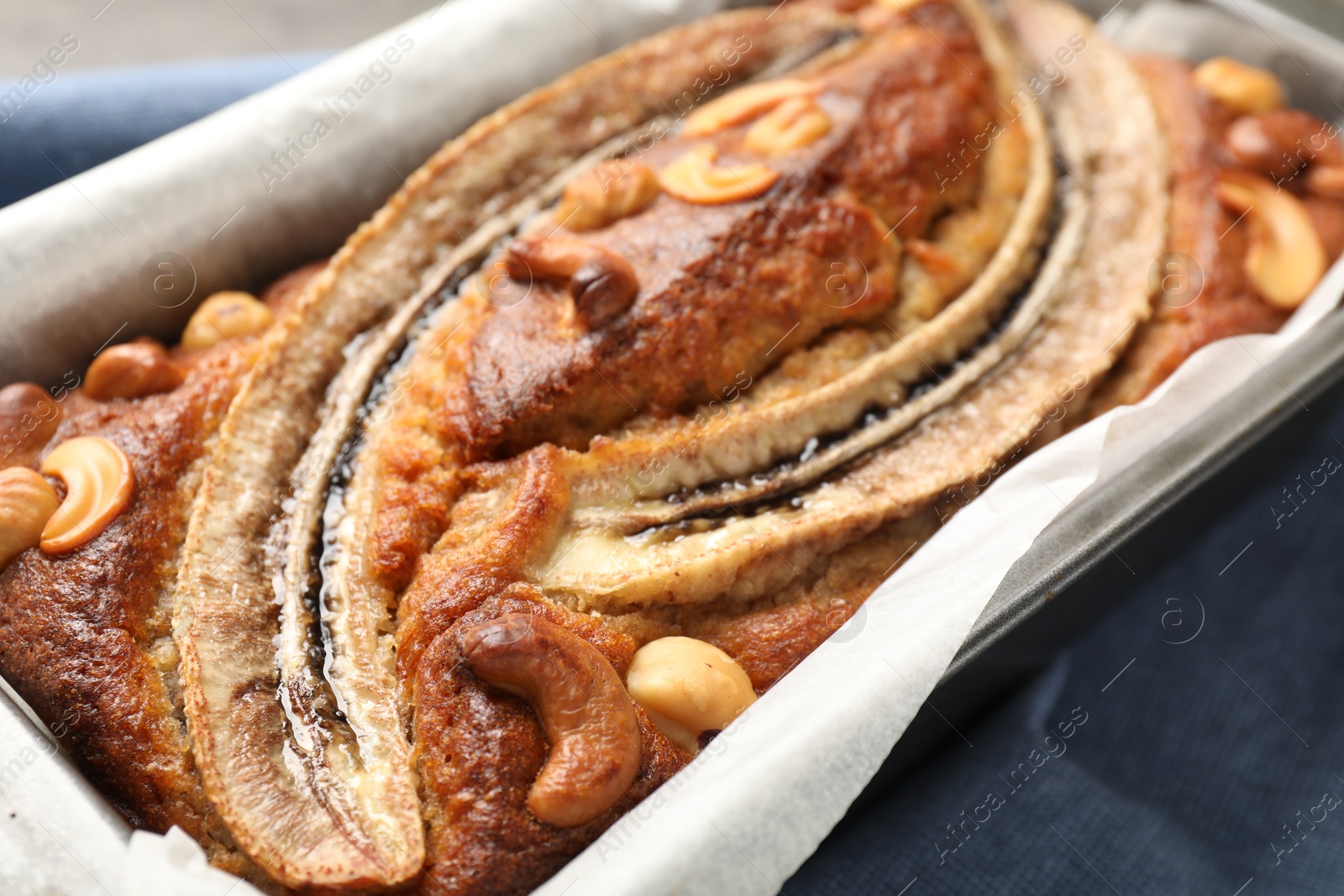 Delicious banana bread with nuts on table, closeup Photo of Delicious banana bread with nuts on table, closeup