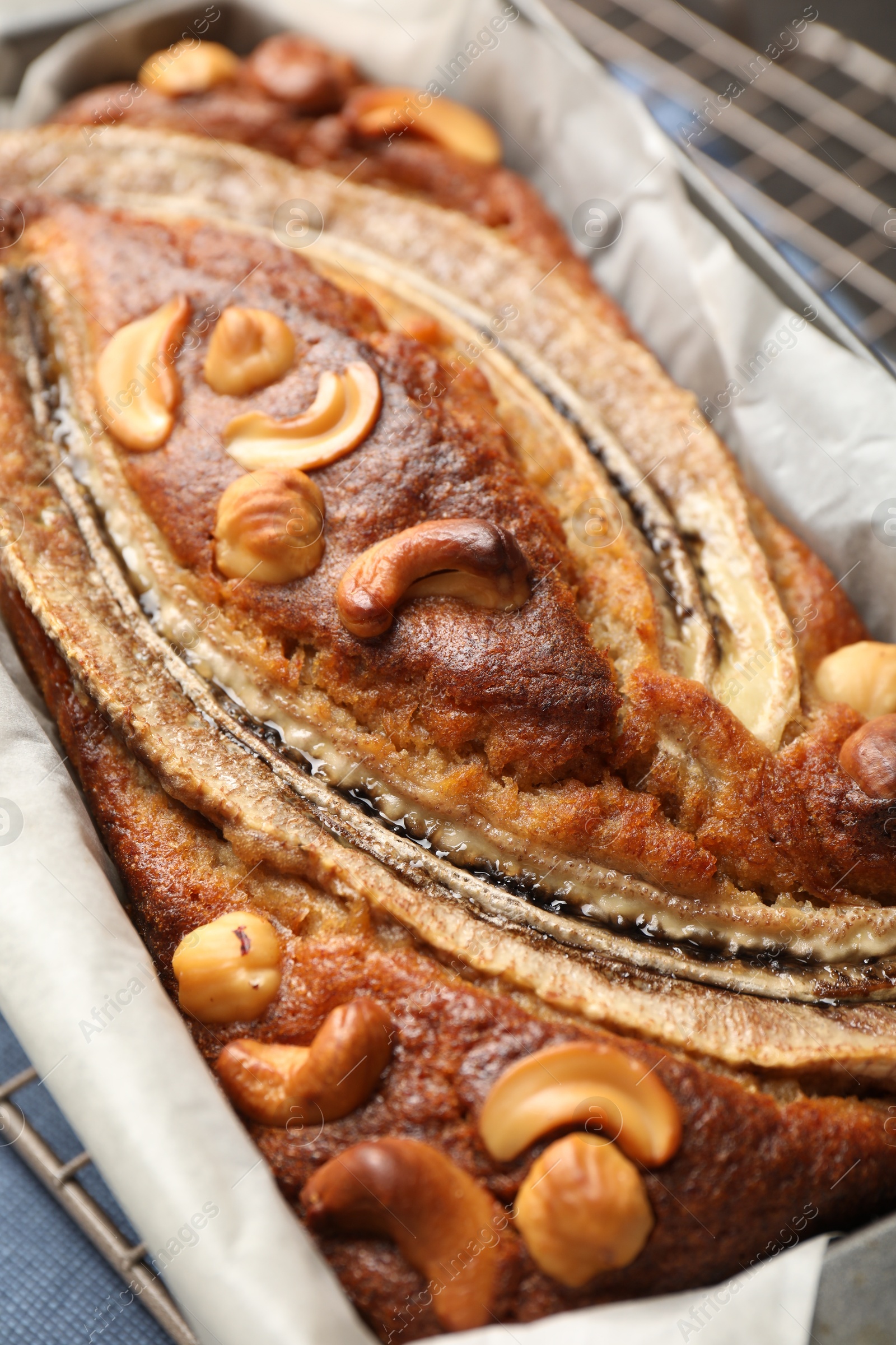 Delicious banana bread with nuts on table, closeup Photo of Delicious banana bread with nuts on table, closeup