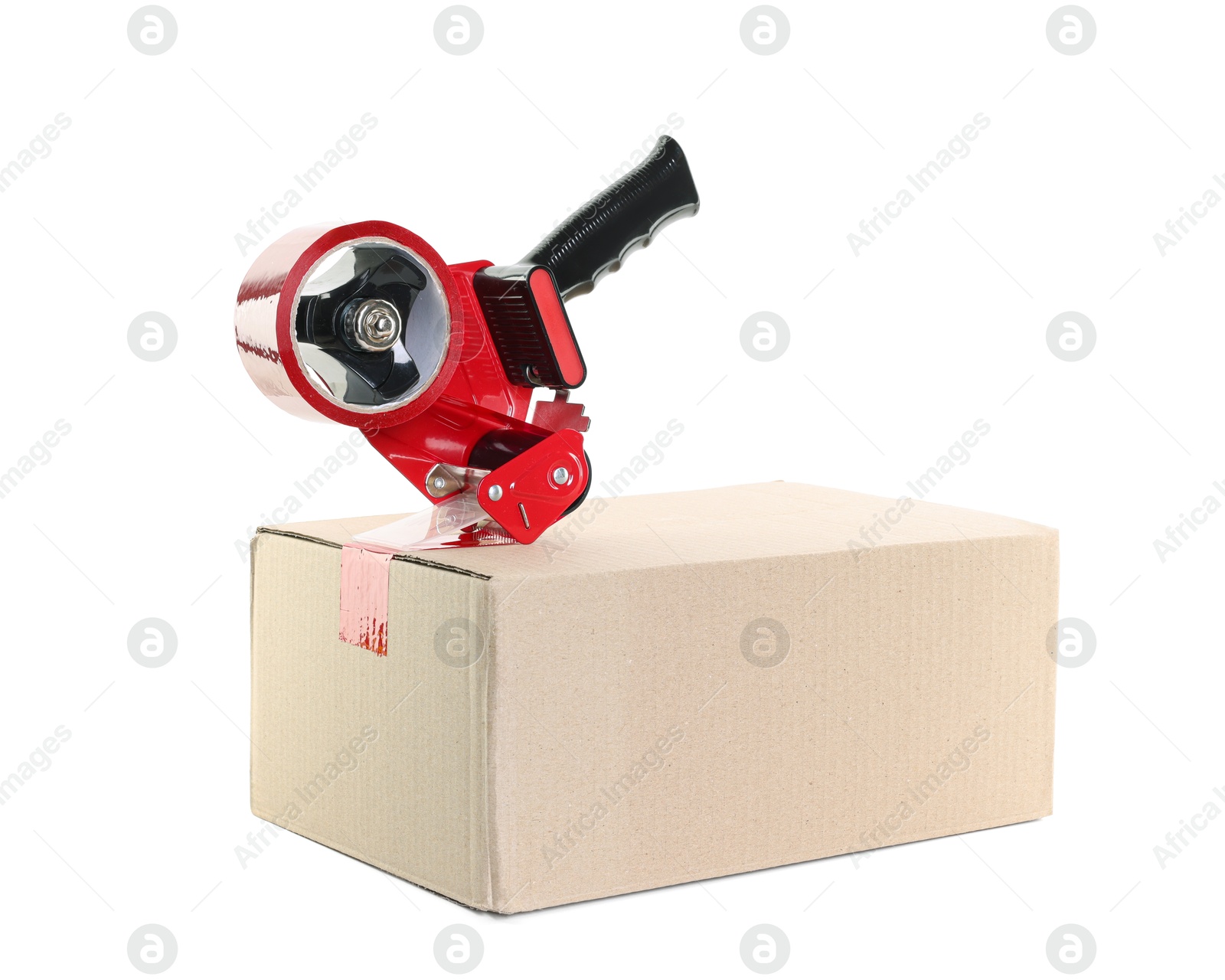 Photo of Dispenser with adhesive tape on cardboard box against white background